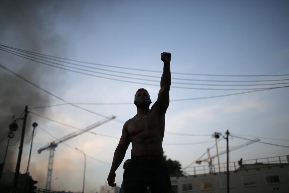 FILE - In this Tuesday, June 2, 2020 file photo a protester raises his fist during a demonstration against police violence and racial injustice. The Paris demonstrators declared "We are all George Floyd," but also invoked the name of Adama Traore, a 24-year-old Frenchman of Malian origin who died in police custody in 2016. The circumstances are still under investigation by justice authorities. (AP Photo/Rafael Yaghobzadeh, File)