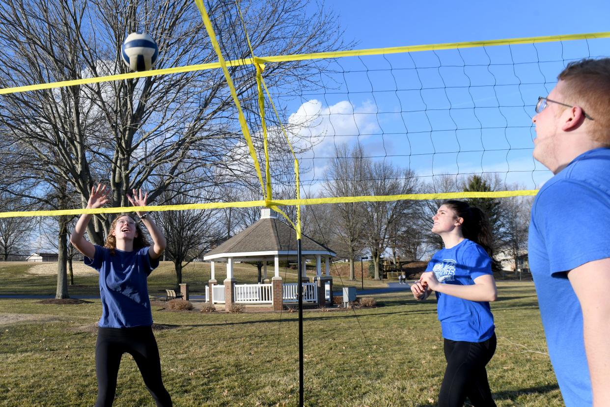 First Baptist Church of Jackson Youth Group members, including Mallory Carbenia, Emily Smith and Sam Werstler play a game of Cross Net during an outing at North Park in Jackson Township on an unseasonably warm winter day.