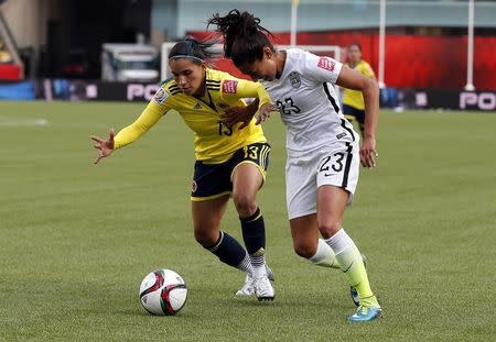 Jun 22, 2015; Edmonton, Alberta, CAN; Colombia defender Angela Clavijo (13) and United States forward Christen Press (23) fight for the ball during the second half in the round of sixteen in the FIFA 2015 women's World Cup soccer tournament at Commonwealth Stadium. Mandatory Credit: Erich Schlegel-USA TODAY Sports -