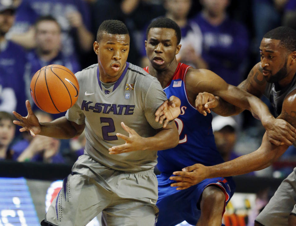 Kansas State guard Marcus Foster (2) tries to go around Kansas guard Andrew Wiggins, center, during the first half of an NCAA college basketball game in Manhattan, Kan., Monday, Feb. 10, 2014. (AP Photo/Orlin Wagner)