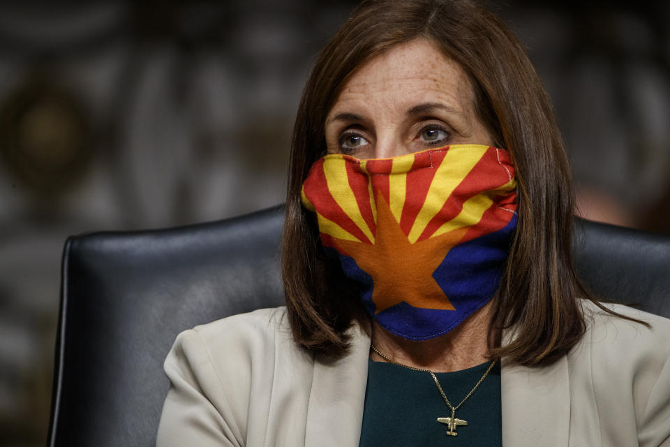 FILE - In this May 6, 2020, file photo, Sen. Martha McSally, R-Ariz., listens during a hearing on Capitol Hill in Washington. Arizona will be in the national spotlight in November as a presidential battleground and the home of one of the most closely watched Senate contests in the country. But Tuesday's primary on Aug. 4 features few big-ticket contests. McSally faces a challenge from businessman Daniel McCarthy, who is running to her right with an anti-government message and an appeal to voters who think the response to the pandemic is infringing on individual freedoms. (Shawn Thew/Pool via AP, File)