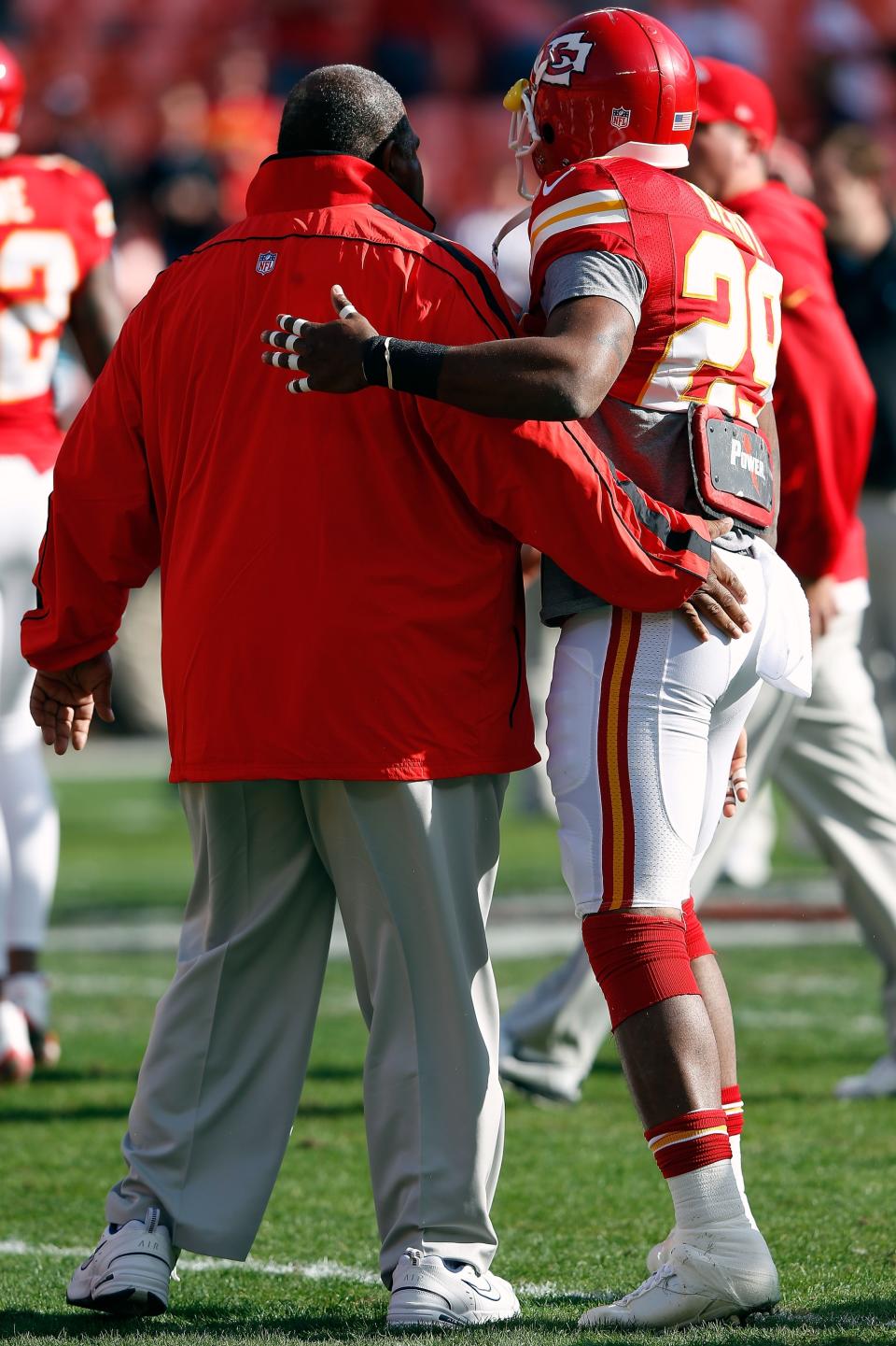 KANSAS CITY, MO - DECEMBER 02: Head coach Romeo Crennel of the Kansas City Chiefs receives a hug from strong safety Eric Berry #29 during player warm-ups prior to the game against the Carolina Panthers at Arrowhead Stadium on December 2, 2012 in Kansas City, Missouri. (Photo by Jamie Squire/Getty Images)