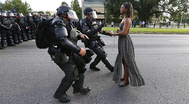The identity of the woman pictured in front of heavily armed police in Baton Rouge is as yet unknown. Photo: Reuters/Jonathan Bachman