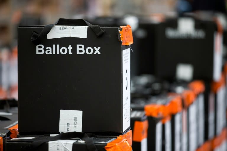 Sealed ballot boxes containing voting slips wait to be processed in north London on May 6, 2016