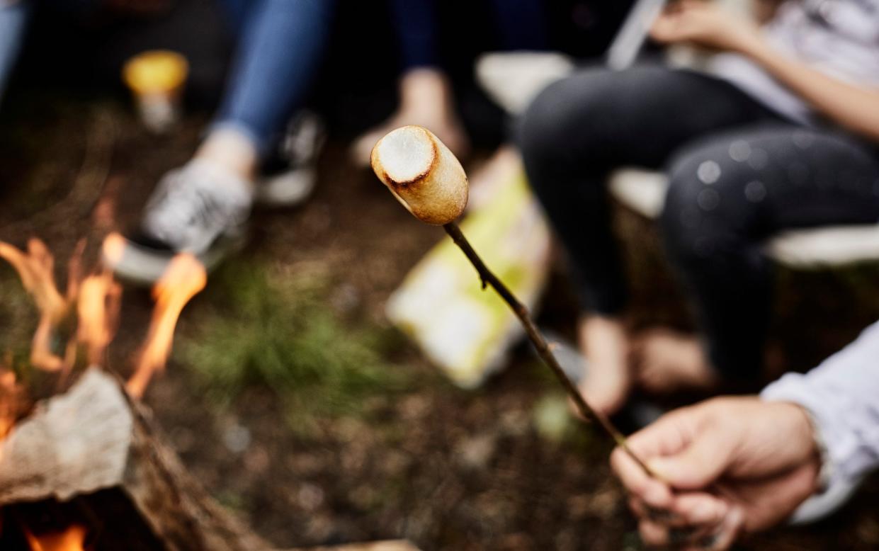 Roasting a marshmallow at camp fire