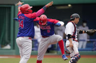 Dominican Republic's Erick Mejia(6) and Juan Francisco (34) celebrate after they scored on a double hit by Charlie Valerio during the seventh inning of a baseball game against Japan at the 2020 Summer Olympics, Wednesday, July 28, 2021, in Fukushima, Japan. (AP Photo/Jae C. Hong)