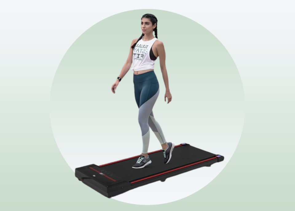 white woman with dark hair walking on a treadmill