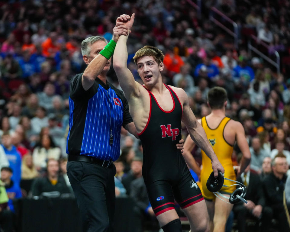 Nashua-Plainfield's Garret Rinken gets his hand raised Saturday after defeating Wapsie Valley's Dawson Schmit at 126 pounds during the championship round of the Class 1A state wrestling tournament.