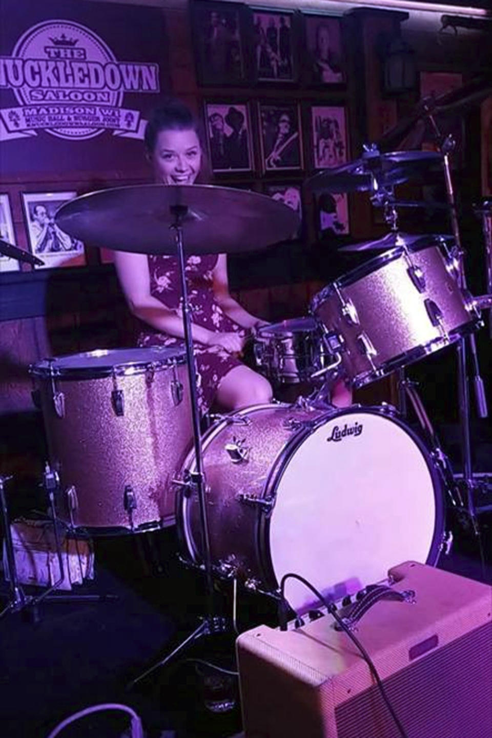 This August 2018 photo shows Sarah Papenheim posing on a drum set at a bar in Madison, Wis. Sarah Papenheim, a native of Minnesota, was fatally stabbed Wednesday, Dec. 14, 2018, at her home in an apartment building near Erasmus University in Rotterdam, Netherlands, where she had been studying since 2016. (Courtesy of Adam Pryor via AP)