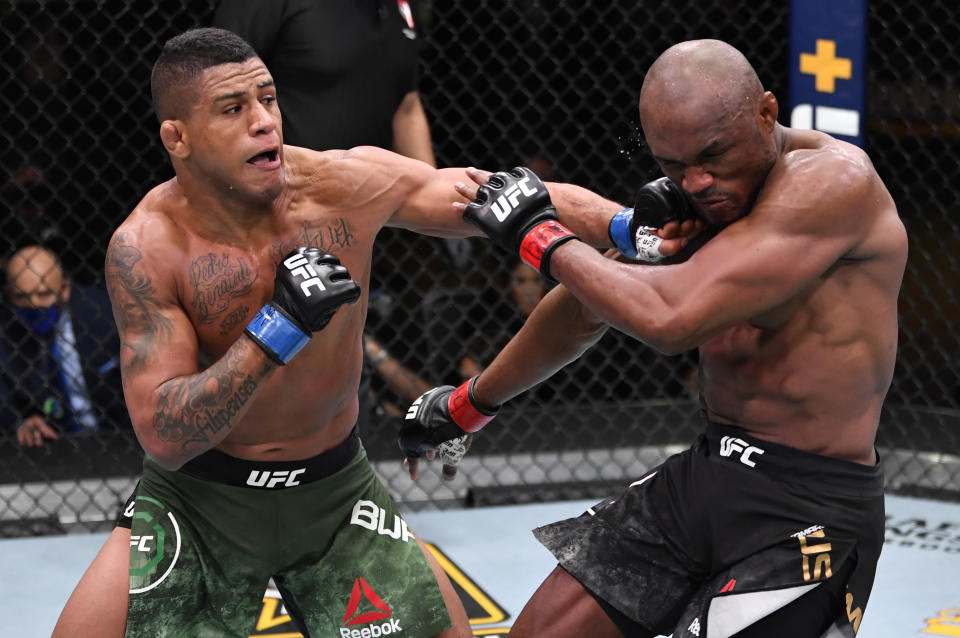 LAS VEGAS, NEVADA - FEBRUARY 13: In this handout image provided by UFC, (L-R) Gilbert Burns of Brazil punches Kamaru Usman of Nigeria in their UFC welterweight championship fight during the UFC 258 event at UFC APEX on February 13, 2021 in Las Vegas, Nevada. (Photo by Jeff Bottari/Zuffa LLC via Getty Images)