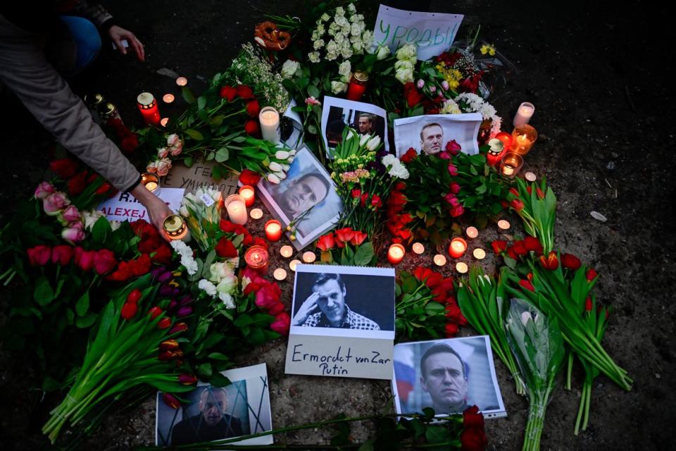 Flowers and candles are left at a memorial on Feb. 16, 2024, in front of the Russian embassy in Berlin, after the announcement that the Kremlin's most prominent critic Alexei Navalny had died in an Arctic prison. (John Macdougall/AFP via Getty Images)