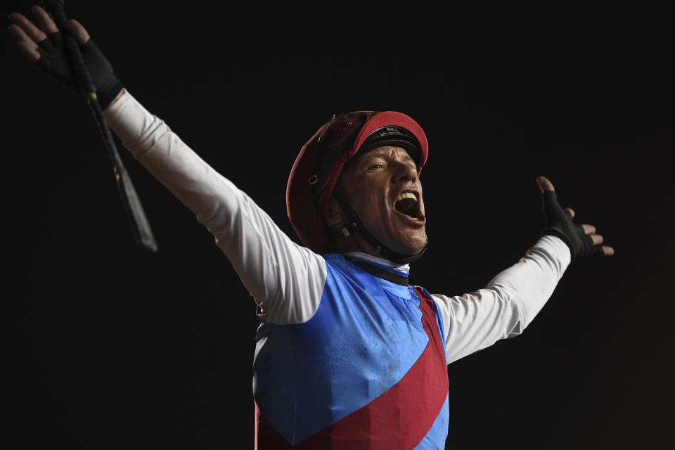 Country Grammer's jockey Frankie Dettori reacts after winning Group 1 Dubai World Cup over 2000m (10 furlongs) at Meydan Racecourse in Dubai, United Arab Emirates, Saturday, March 26, 2022. (AP Photo/Martin Dokoupil)