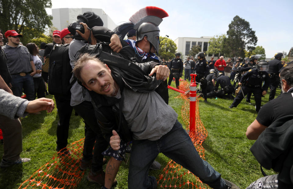 A protestor is pulled from a confrontation by a pro-Trump supporter during the Patriots Day Free Speech Rally in Berkeley, California, U.S. April 15, 2017. REUTERS/Jim Urquhart