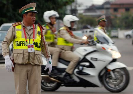 Traffic police work on the street before ASEAN Summit in Vientiane, Laos September 5, 2016. REUTERS/Soe Zeya Tun