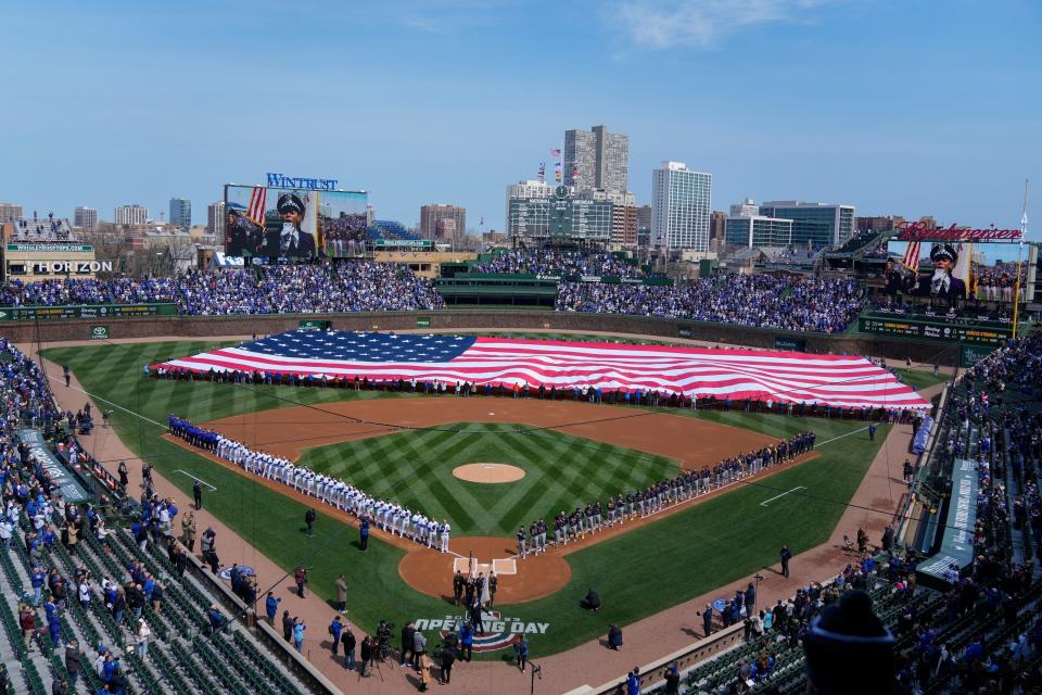 An American flag is unfurled in the outfield before at Wrigley Field before the opening day baseball game between the Chicago Cubs and Milwaukee Brewers, Thursday, March 30, 2023, in Chicago. (AP Photo/Erin Hooley)