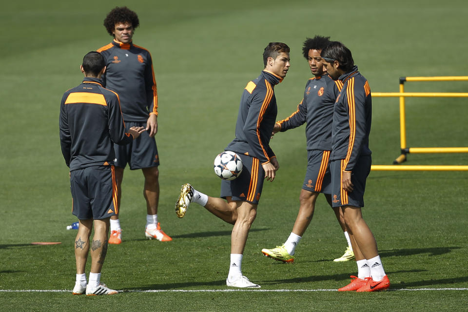 Real's Cristiano Ronaldo, center, controls the ball next to teammates during a training session in Madrid, Spain, Tuesday, April 22, 2014. Real Madrid will face Bayern Munich in a first leg semifinal Champions League soccer match on Wednesday. (AP Photo/Gabriel Pecot)