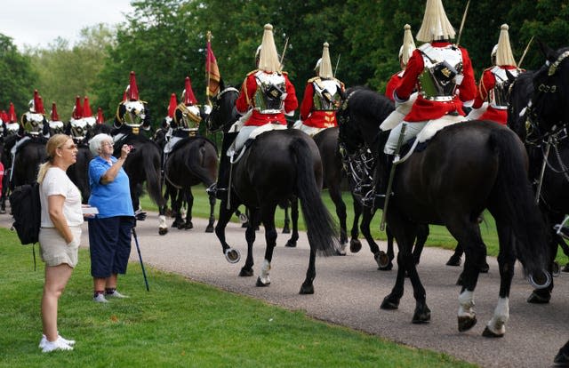 Members of the Household Cavalry make their way down the Long Walk towards Windsor Castle ahead of the ceremony