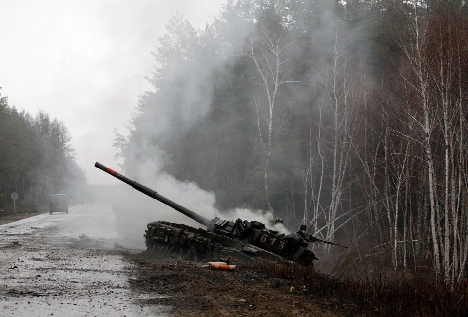 Smoke rises from a Russian tank destroyed by Ukrainian forces, on the side of a road in Lugansk region on Feb. 26, 2022.<span class="copyright">AFP via Getty Images</span>