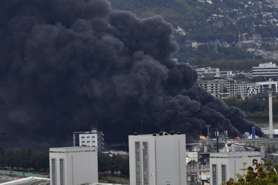 Black smoke is pictured after a fire broke at a chemical plant in Rouen, Normandy, Thursday, Sept.26, 2019. An immense mass of black smoke is rising over Normandy as firefighters battle a blaze at a chemical plant, and authorities closed schools in 11 surrounding towns and asked residents to stay indoors. (AP Photo/Stephanie Peron)