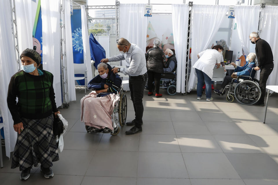 Israelis arrive to receive a vaccine against the COVID-19 coronavirus at Clalit Health Services, in the coastal city of Tel Aviv, on January 3, 2021. - Israel said two million people will have received a two-dose COVID-19 vaccination by the end of January, since the start on December 19, of an aggressive push to administer the vaccine made by US-German pharma alliance Pfizer-BioNTech. (Photo by JACK GUEZ / AFP) (Photo by JACK GUEZ/AFP via Getty Images)