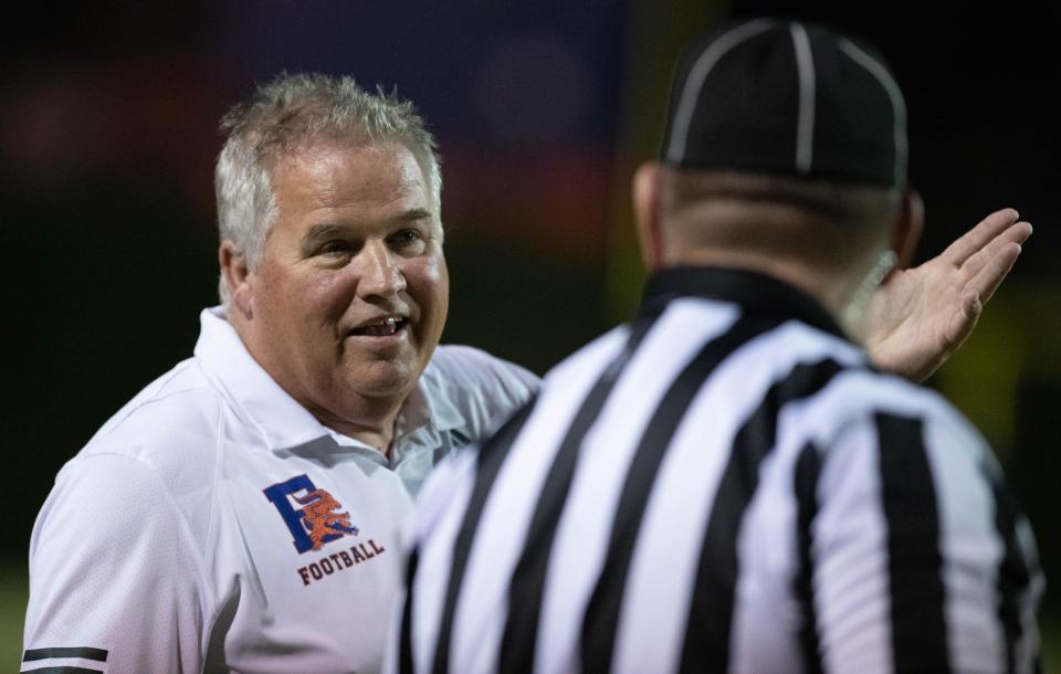 Gators head coach Mike Bennett has a chat with a referee during the Washington vs Escambia football game at Escambia High School in Pensacola on Friday, Sept. 29, 2023.