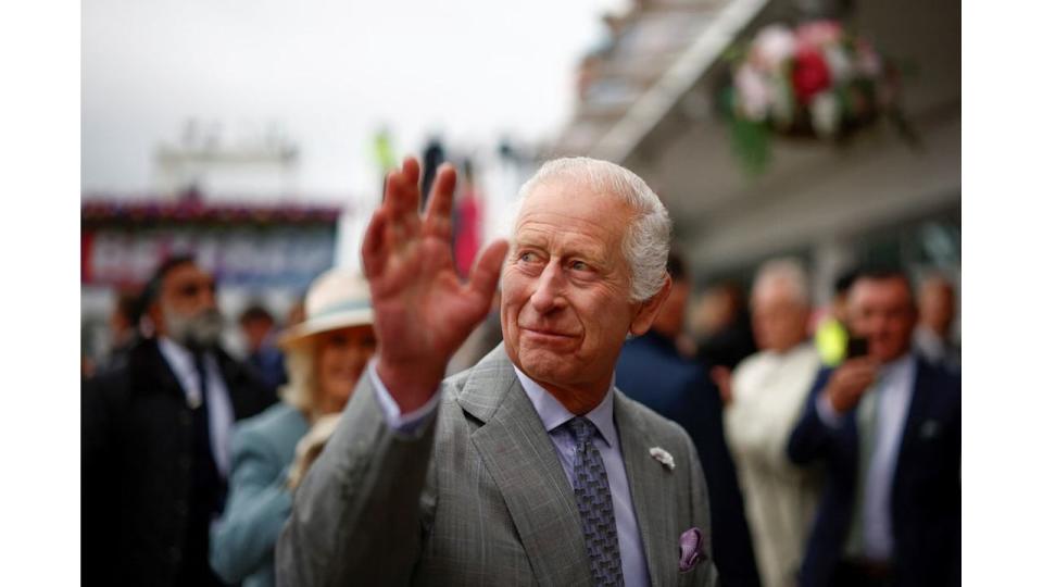 King Charles waving at members of the public