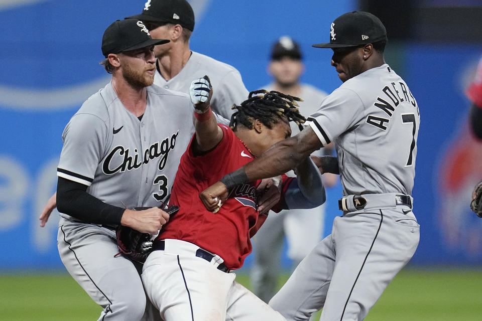 Chicago White Sox's Michael Kopech, left, holds Cleveland Guardians' Jose Ramírez, center, as White Sox's Tim Anderson throws a punch during the sixth inning of a baseball game Saturday, Aug. 5, 2023, in Cleveland. Anderson and Ramírez were among those ejected. (AP Photo/Sue Ogrocki)