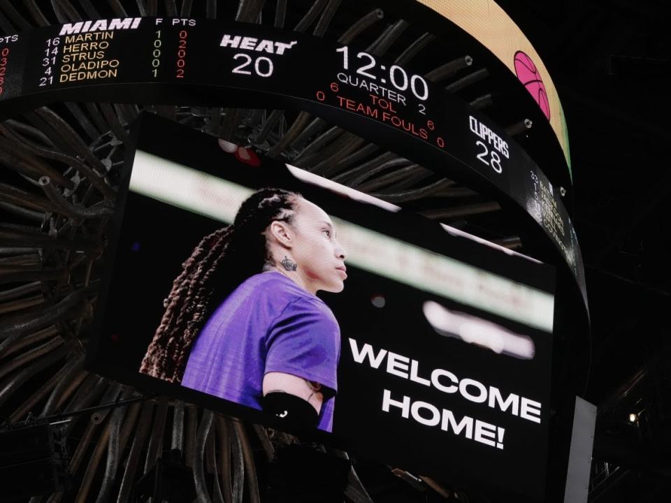 A graphic welcoming home WNBA star Brittney Griner is displayed on the video board prior to an NBA game between the Miami Heat and the L.A. Clippers at FTX Arena in Miami on Thursday. Griner was released from a Russian prison earlier in the day and boarded a plane back to the U.S. (Jasen Vinlove/USA Today Sports - image credit)