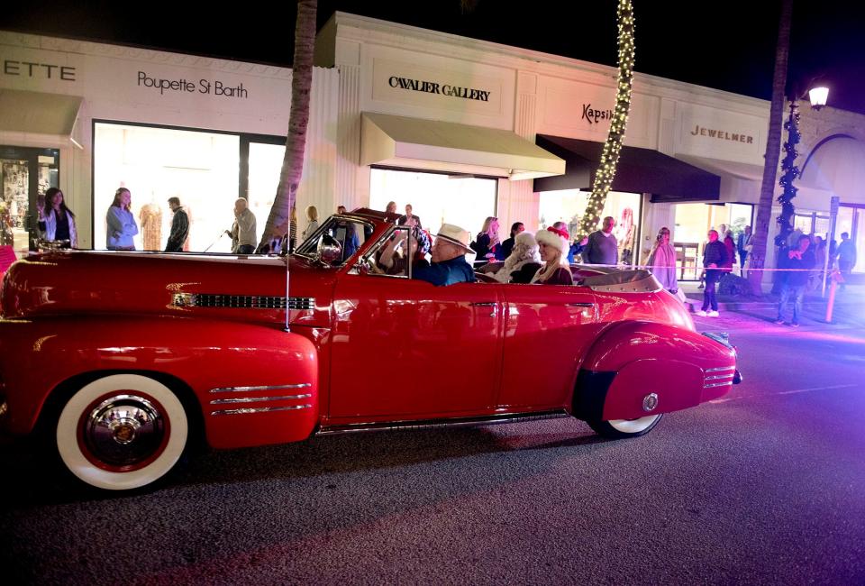 Santa Claus is driven in the parade on Worth Avenue before the holiday tree-lighting event.