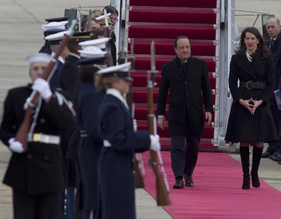 ** CORRECTS THAT JONES IS ACTING CHIEF OF PROTOCOL ** French President Francois Hollande, escorted by US acting Chief of Protocol Natalie Jones, walks during a honor guard review upon his arrival at Andrews Air Force Base, Md., Monday Feb. 10, 2014, for a three-day visit to U.S. ( AP Photo/Jose Luis Magana)