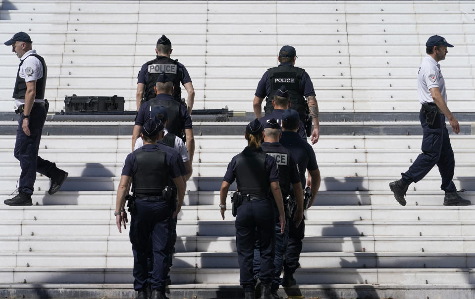 Members of the police are seen in front of the entrance to the Palais des Festival prior to the 74th international film festival, Cannes, southern France, July 5, 2021. The Cannes film festival runs from July 6 - July 17. (AP Photo/ Brynn Anderson)