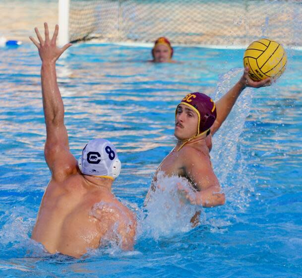 Los Angeles, CA - December 05: USC driver Carson Kranz takes a shot while guarded by Cal's Garrett Dunn in the first half at Spieker Aquatics Center on Sunday, Dec. 5, 2021 in Los Angeles, CA. (Steve Galluzzo / For The Times)