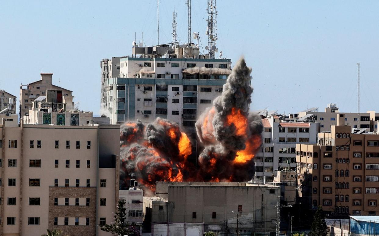 A ball of fire erupts from the Jala Tower as it is destroyed in an Israeli airstrike in Gaza city