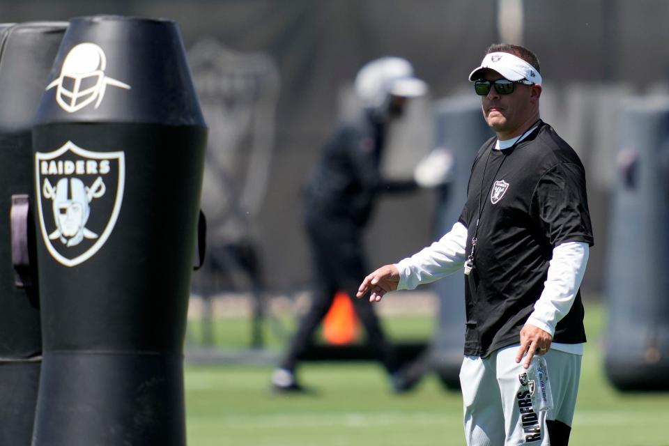 Las Vegas Raiders head coach Josh McDaniels watches during practice at the NFL football team's practice facility Tuesday, June 7, 2022, in Henderson, Nev. (AP Photo/John Locher)