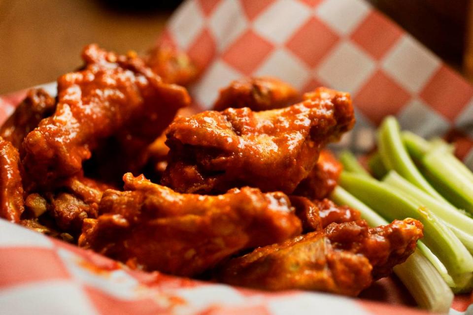 You have a choice of 14 different sauces, including blazing buffalo pictured here, for Woody’s jumbo wings at Woody’s at City Market in Raleigh.