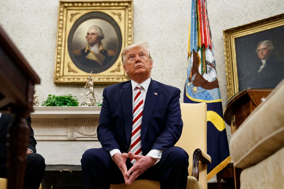 President Donald Trump pauses while speaking during a meeting with Romanian President Klaus Iohannis in the Oval Office of the White House, Tuesday, Aug. 20, 2019, in Washington.