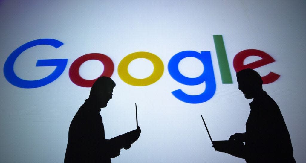 ANKARA, TURKEY - SEPTEMBER 04: Silhouettes of people holding laptops are seen in front of the logo of 'Google' technology company on the 20th anniversary of Google, in Ankara, Turkey on September 04, 2018. (Photo by Aytac Unal/Anadolu Agency/Getty Images)