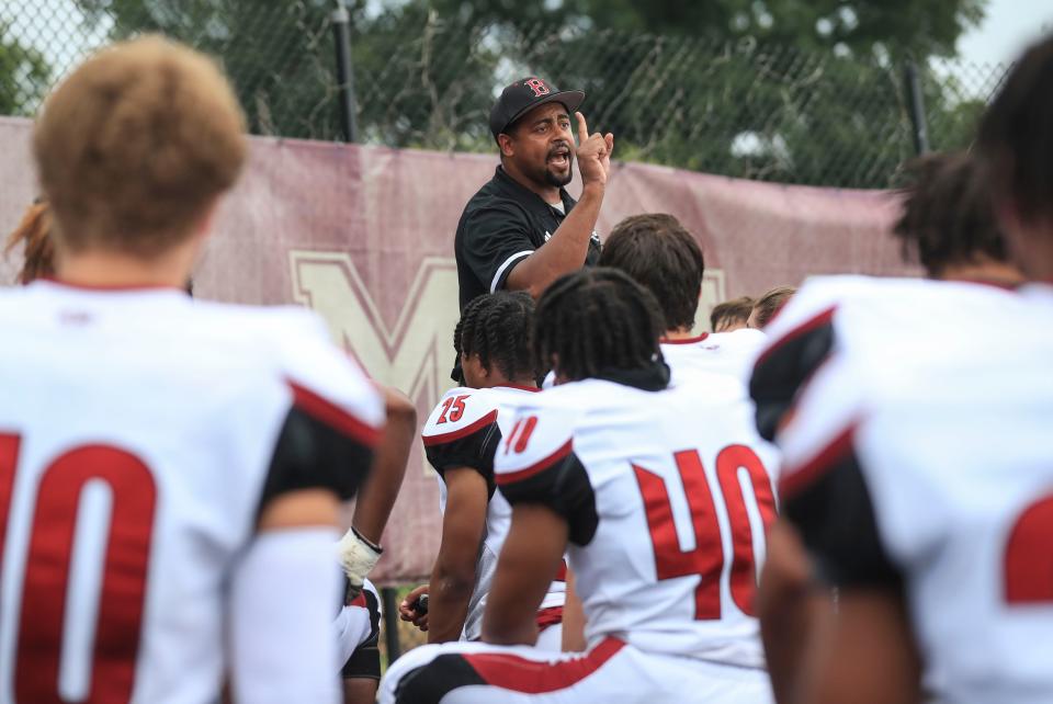 Ballard head football coach Adrian Morton talks to his team before the game against Male. August 27, 2021 