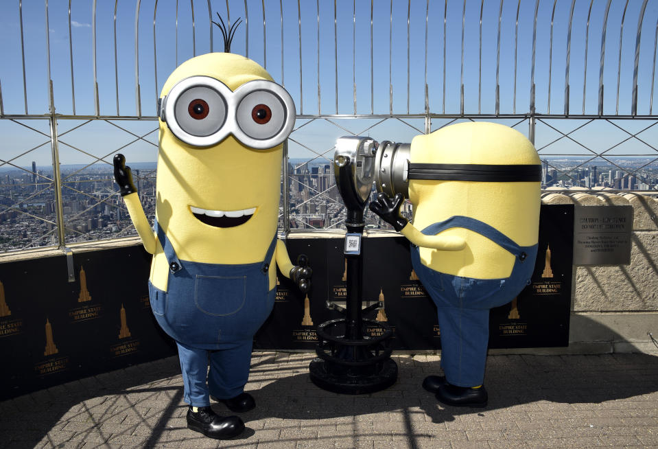 Minion characters Kevin, left, and Bob pose on the 86th floor observatory deck at the Empire State Building to celebrate the upcoming film "Minions: The Rise of Gru" on Tuesday, June 28, 2022, in New York. (Photo by Evan Agostini/Invision/AP)