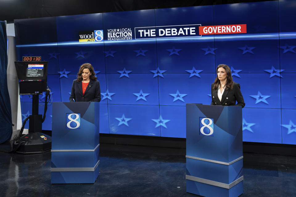 Democratic Gov. Gretchen Whitmer, left, and GOP gubernatorial candidate Tudor Dixon make notes before a Michigan Governor debate, Thursday, Oct. 13, 2022, at WOOD-TV in Grand Rapid, Mich. (Bryan Esler/Nexstar Media Group/WOOD-TV via AP)