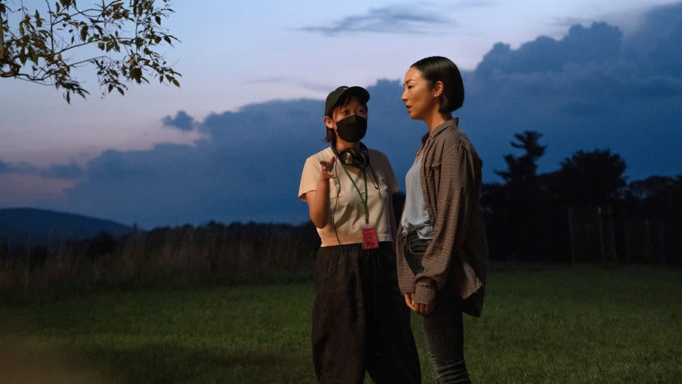Director Celine Song talks to lead actress Greta Lee on the set of "Past Lives." - A24/Everett Collection