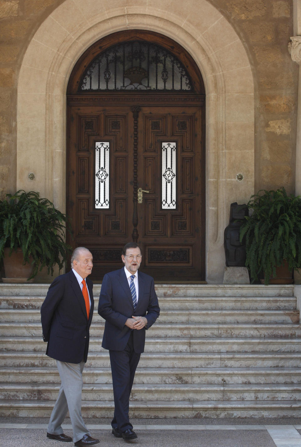 Spain's King Juan Carlos, left, speaks with Spanish Prime Minister Mariano Rajoy before their meeting at the Marivent Palace in Palma de Mallorca, Spain, Tuesday, Aug. 14, 2012. Rajoy said Tuesday he had still not made a decision on asking for more financial aid for his country and would not until the European Central bank made known plans and conditions for for buying troubled government bonds. (AP Photo/Manu Mielniezuk)