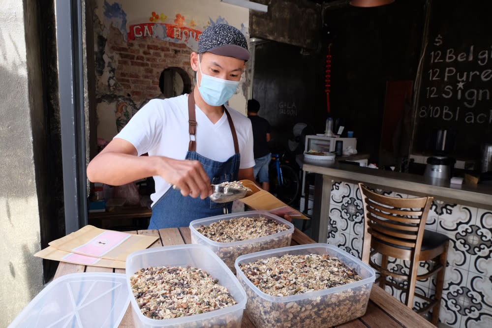 Ong Leng Hin packing the freshly made muesli. — Picture by Steven Ooi KE