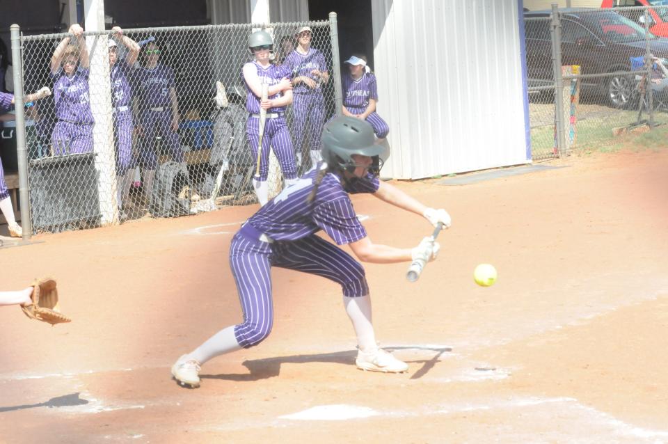 Southeast of Saline's Carly Commerford (14) puts down a bunt during Tuesday's doubleheader against Sacred Heart at Southeast of Saline.