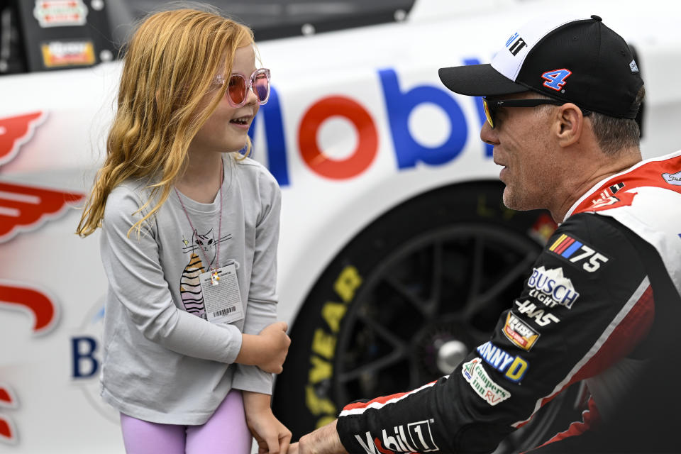 Kevin Harvick, right, shares a moment with his daughter, Piper, prior to a NASCAR Cup Series auto race at Charlotte Motor Speedway, Monday, May 29, 2023, in Concord, N.C. (AP Photo/Matt Kelley)