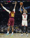 Chicago Bulls' Lonzo Ball (2) shoots over Cleveland Cavaliers' Darius Garland (10) in the first half of an NBA basketball game, Wednesday, Dec. 8, 2021, in Cleveland. (AP Photo/Tony Dejak)