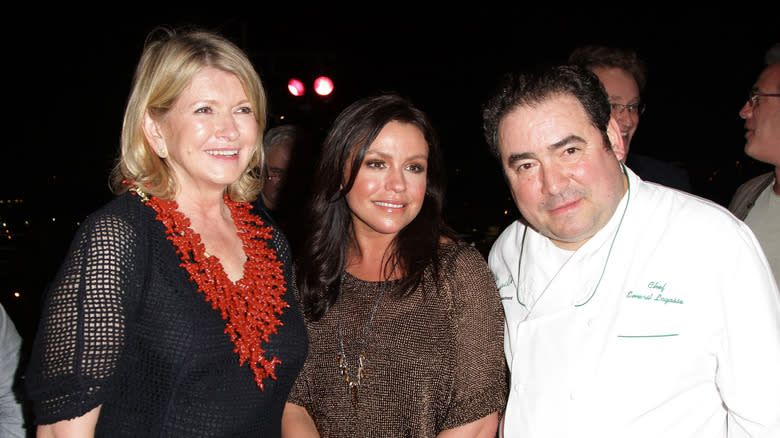 Rachael Ray standing between Martha Stewart and Emeril Lagasse