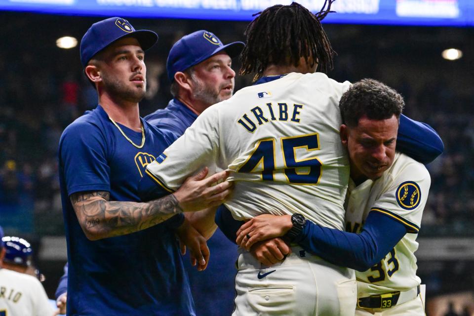 Brewers pitcher Abner Uribe is restrained by teammates during a brawl with the Tampa Bay Rays in the eighth inning Tuesday at American Family Field.