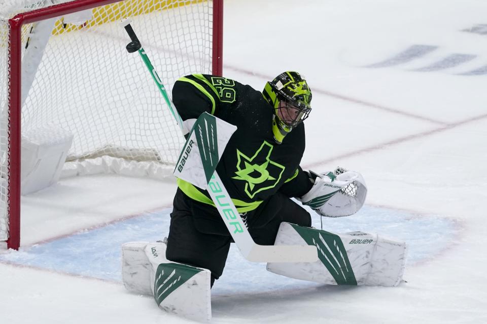 Dallas Stars goaltender Jake Oettinger (29) deflects a shot by the Columbus Blue Jackets in the first period of an NHL hockey game in Dallas, Saturday, March 6, 2021. (AP Photo/Tony Gutierrez)