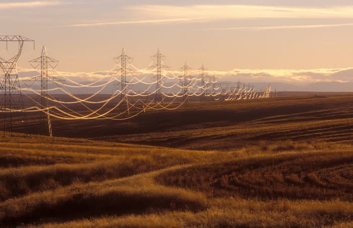 Utility power lines span a rural scene.